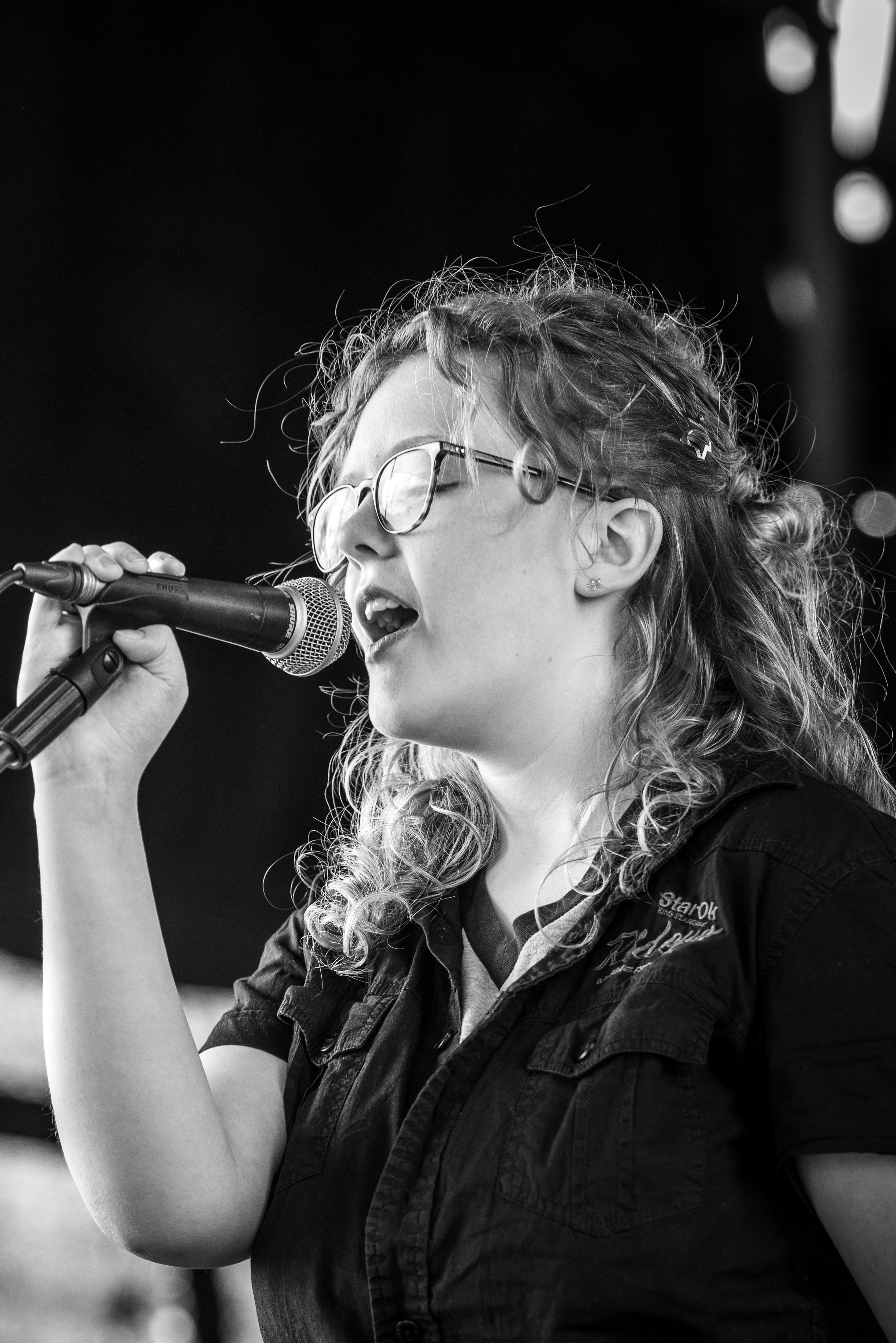 Person singing into microphone. 